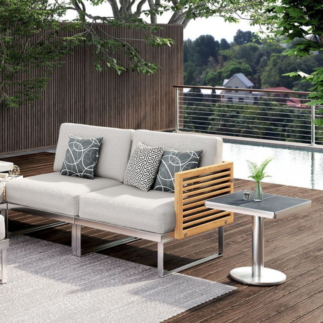 Teak wood sofa with side table and plants.